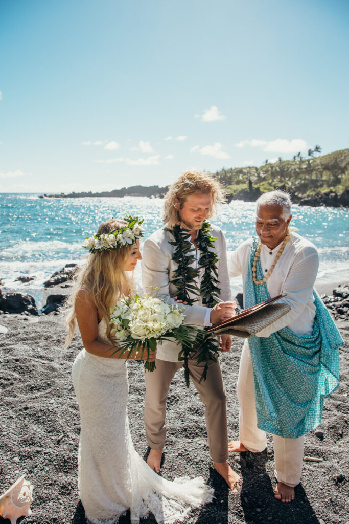 Maui Elopement Photographer captures groom signing marriage certificate