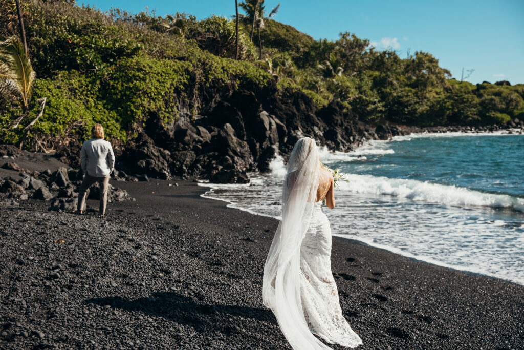 Maui Elopement Photographer captures bride walking up to groom during first look before Hawaii beach wedding