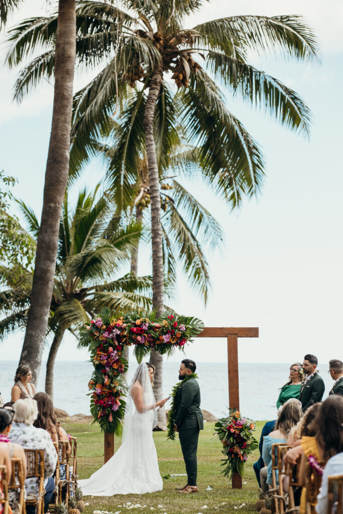 Maui Elopement Photographer captures couple holding hands during Maui beach wedding ceremony