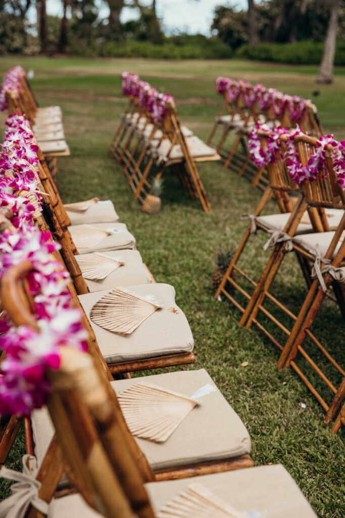 Maui Elopement Photographer captures seats with florals and fans before Maui beach wedding