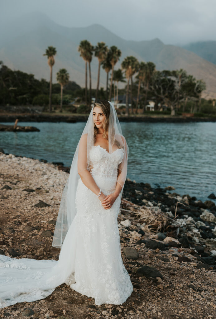 Maui Elopement Photographer captures bride wearing wedding dress and veil before Maui beach wedding