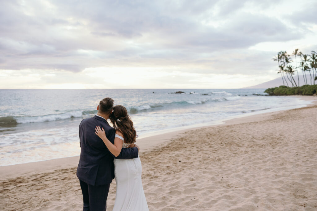 Maui Elopement Photographer captures bride and groom embracing watching the sunset