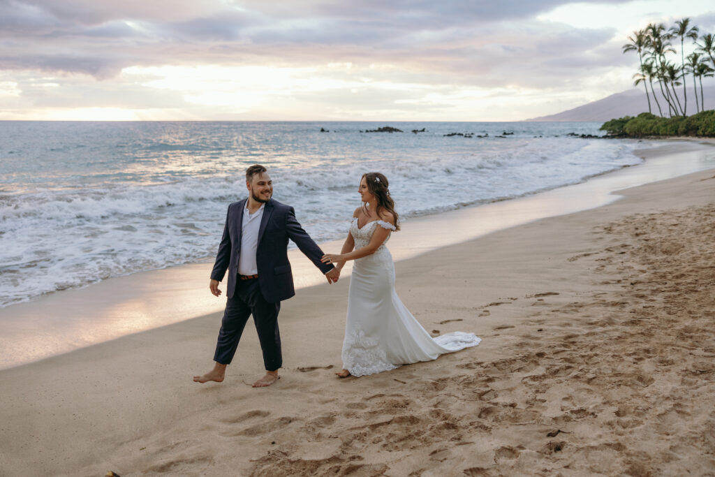 Maui Elopement Photographer captures bride and groom walking on the beach after eloping in Hawaii