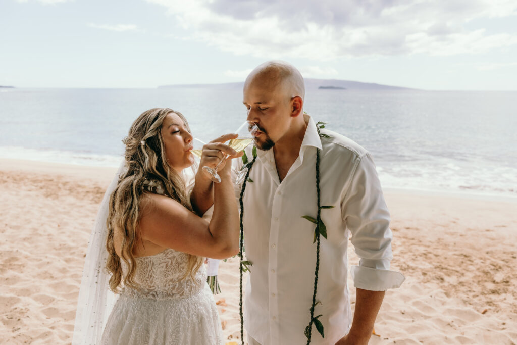 Maui Elopement Photographer captures bride and groom drinking champagne 