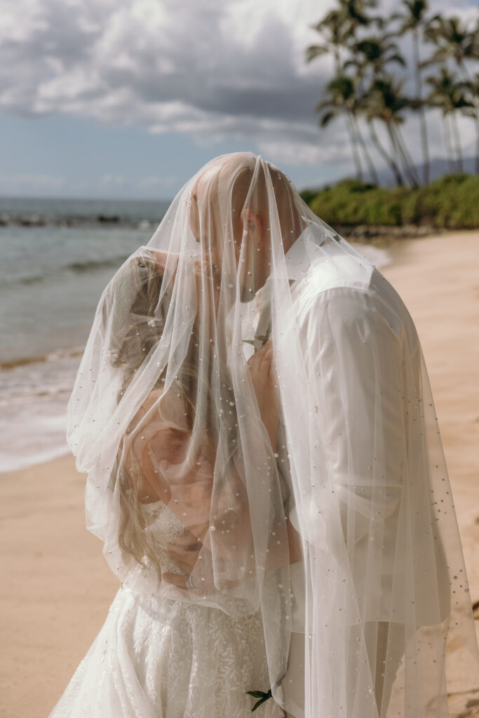 Maui Elopement Photographer captures bride and groom kiss under veil