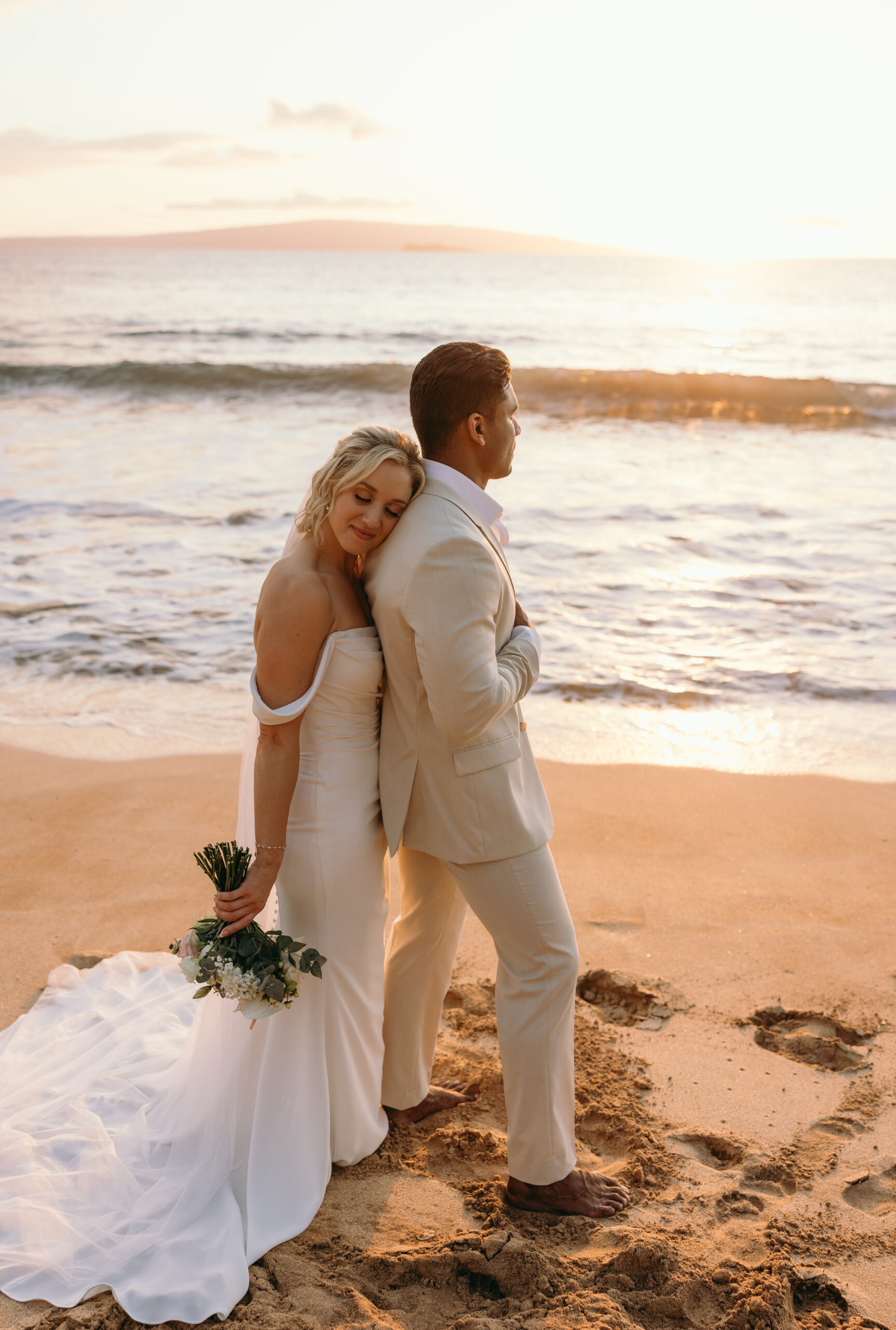 Maui Wedding Photographer captures bride leaning against groom's back during beach bridals