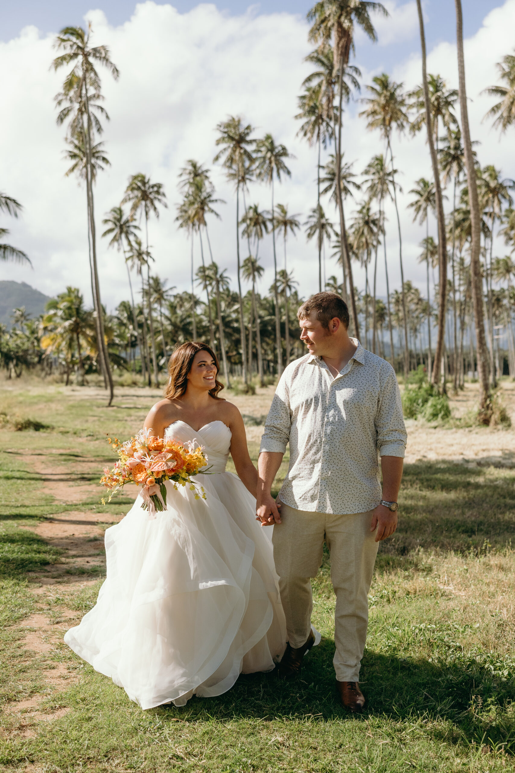 Maui Elopement Photographer captures bride and groom walking together hand in hand after Hawaii wedding