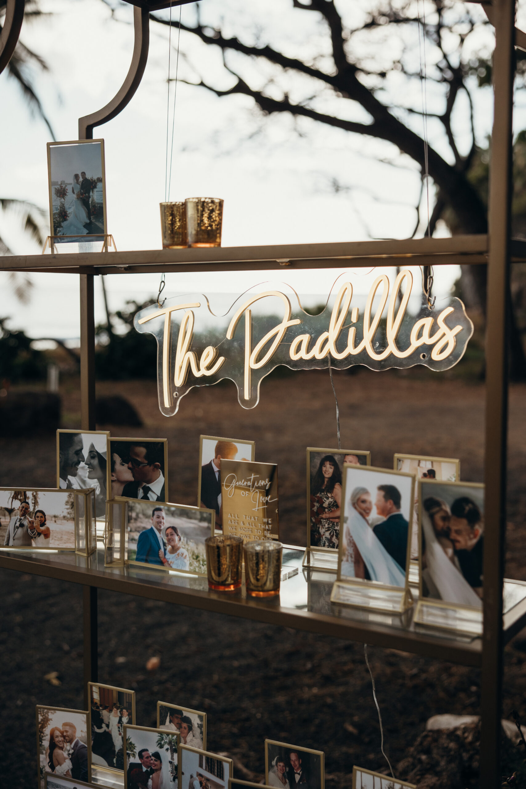 Elegant photo display featuring framed memories of the couple with a glowing “The Padillas” neon sign and gold accents.