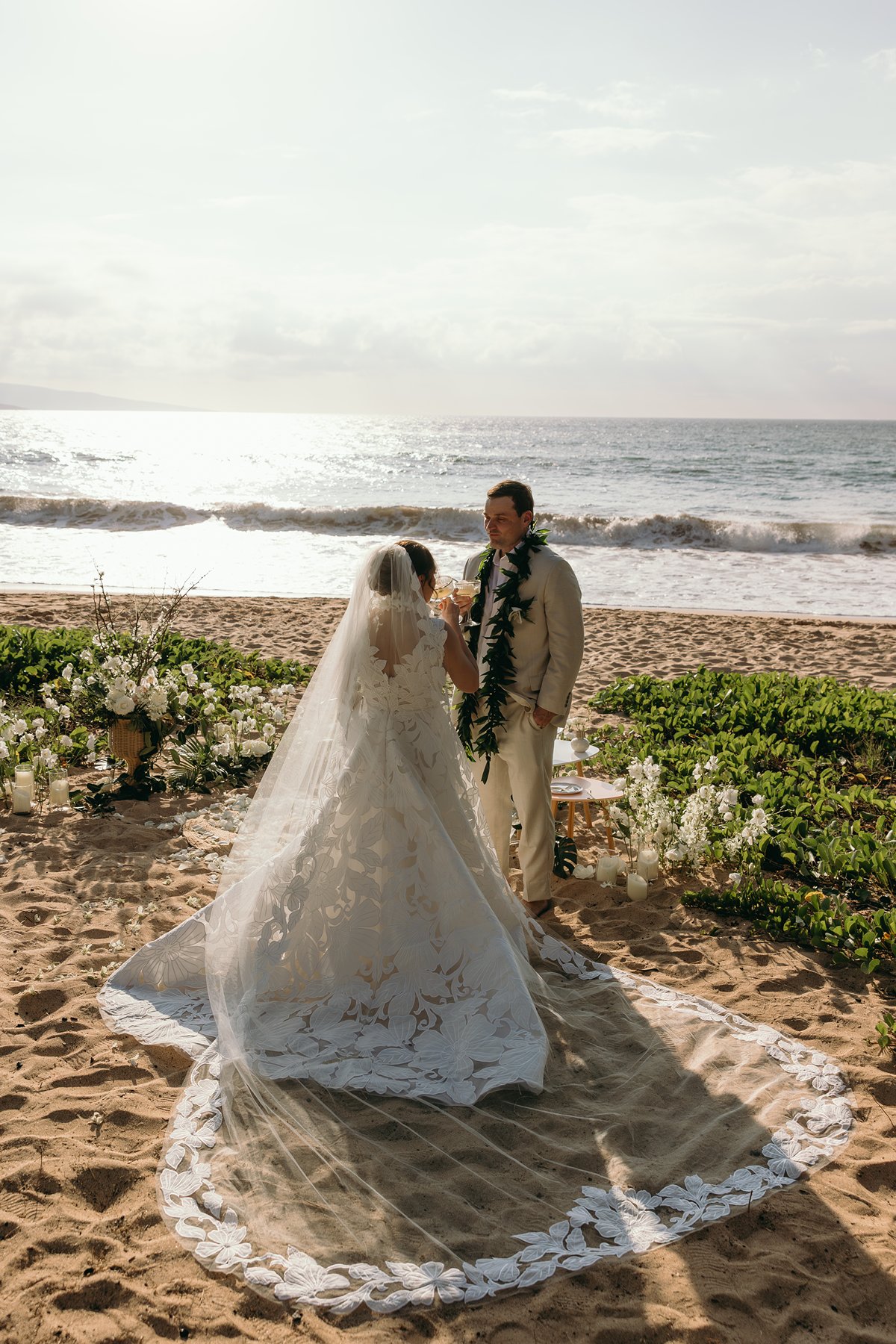 Bride walking toward groom during their intimate Makena beach ceremony with ocean backdrop