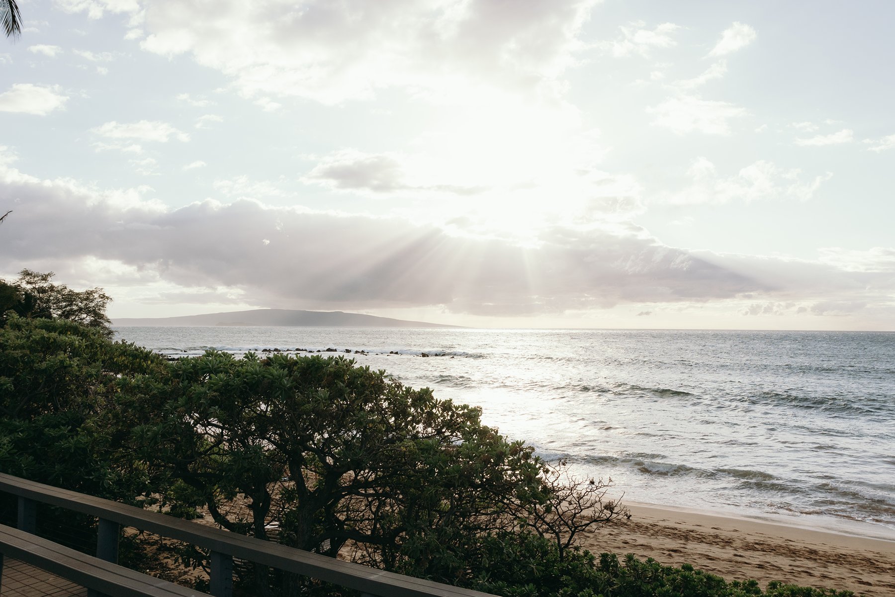 Oceanfront sunset view with waves and shoreline at Hawaii resort wedding venue