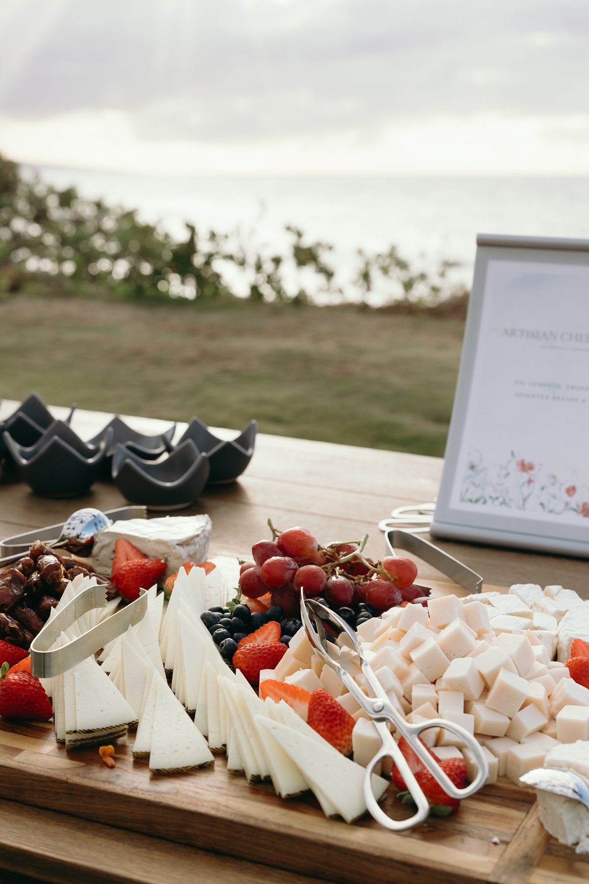 Cheese and fruit grazing table with ocean view at Maui resort wedding venue reception