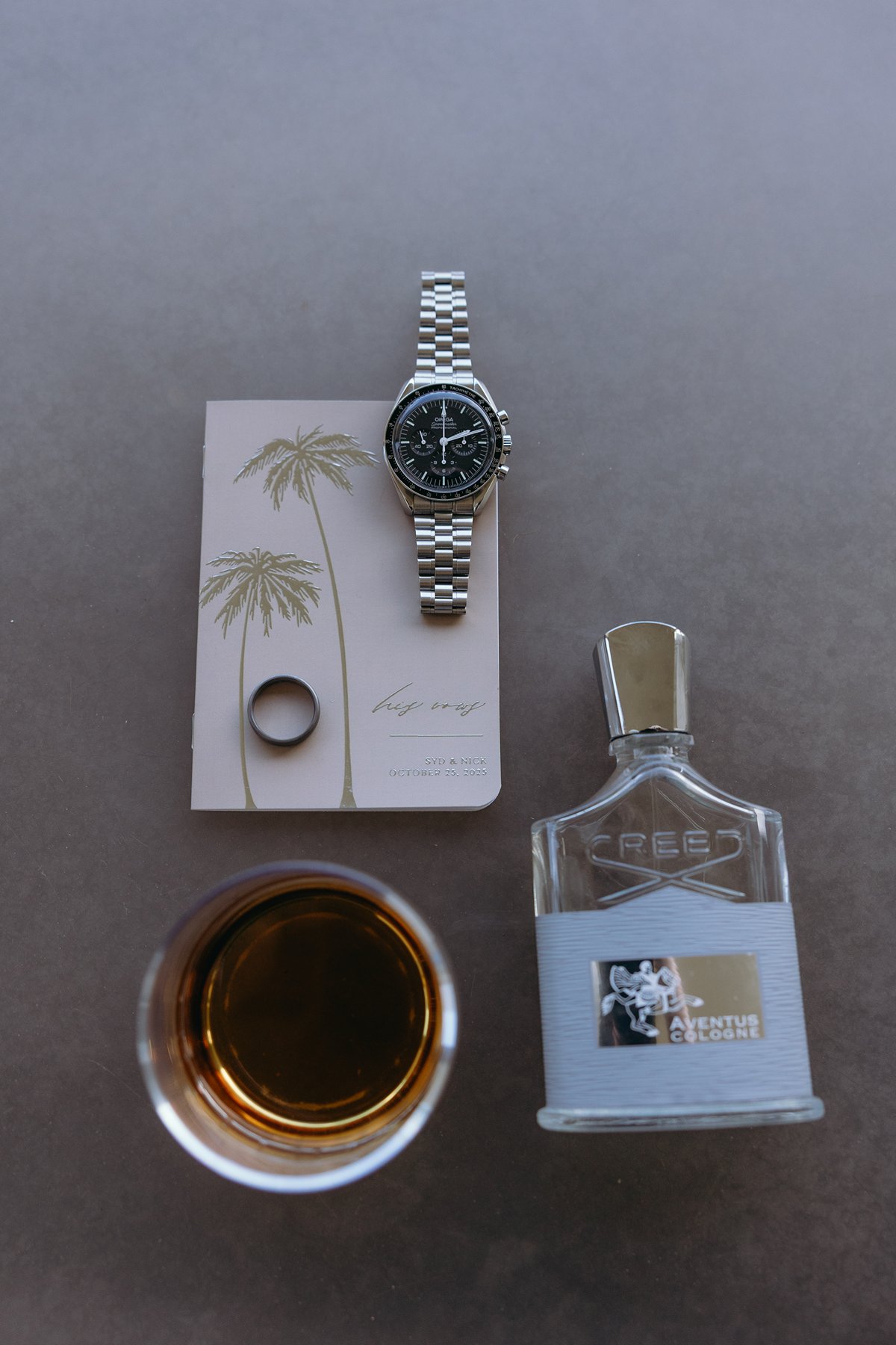 Groom’s wedding details including watch, ring, cologne, and whiskey styled for a Hawaii elopement day.
