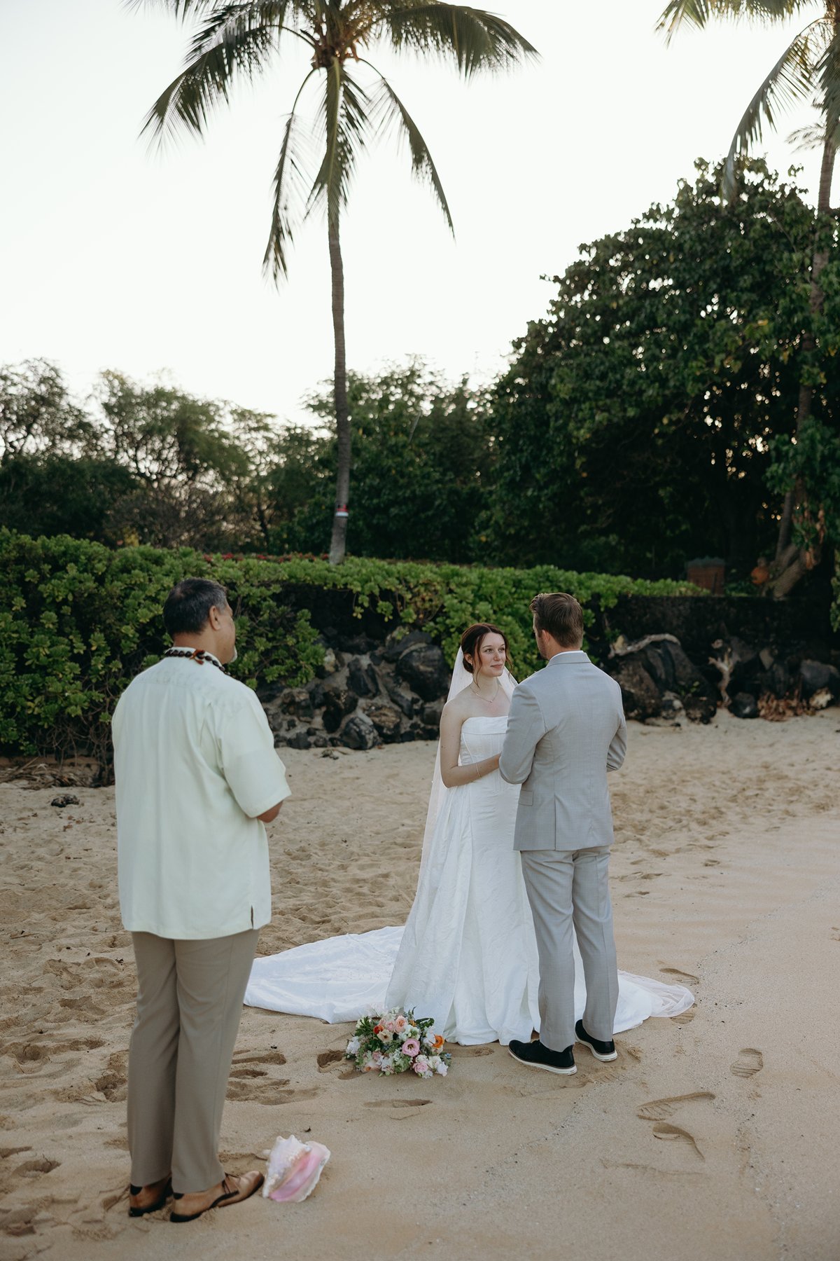Wide view of intimate beach ceremony with couple and officiant in Maui sneak peek photos