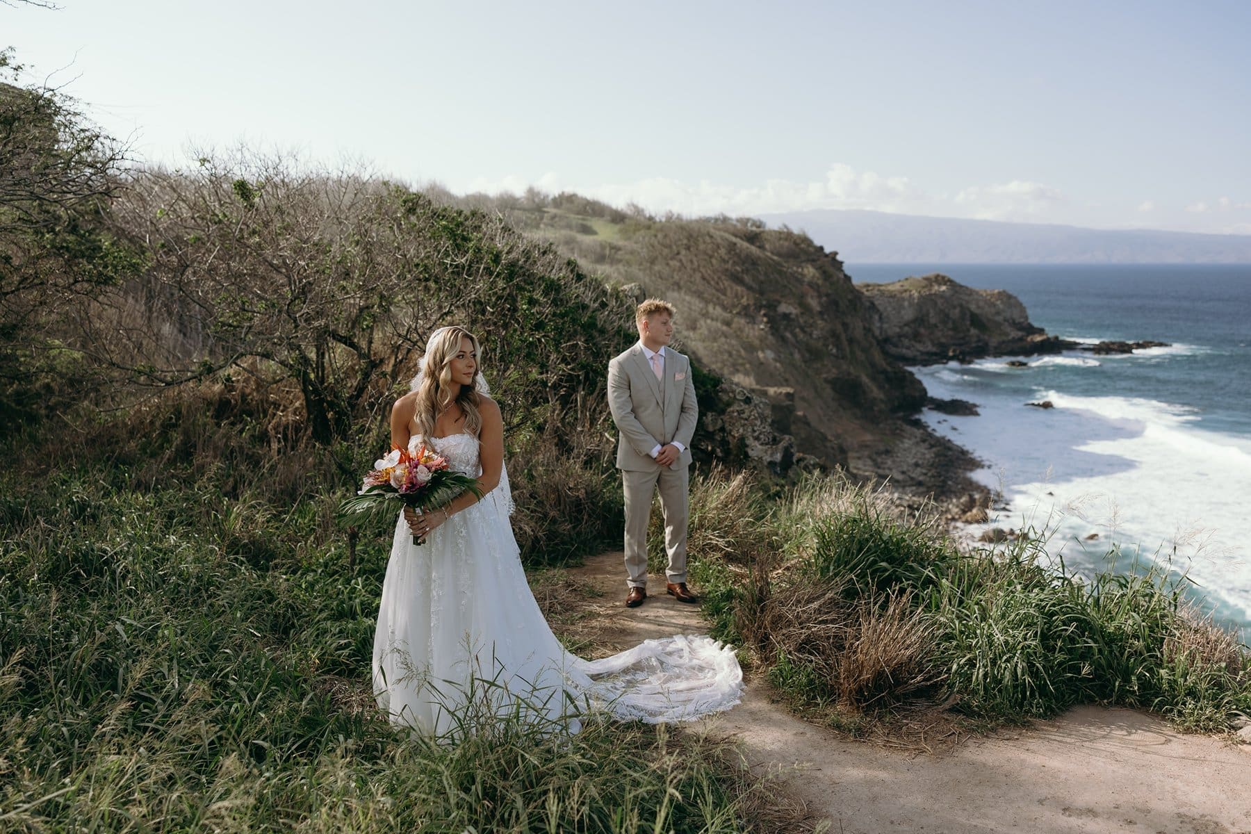 Bride and groom overlooking the coastline before exchanging vows at their intimate Maui elopement